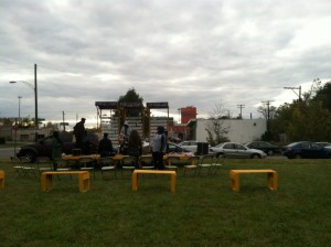 Fellows helping set up the stage for the live band before the community barbeque.